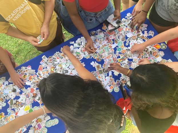 students grabbing stickers