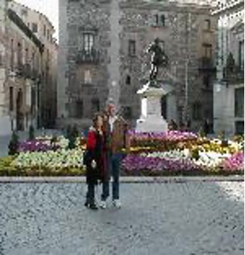 Kiefer and another person in a square in front of a statue