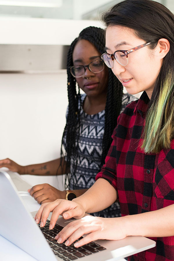 Two women collaborating on laptop computer. Christina Morillo via Pexels