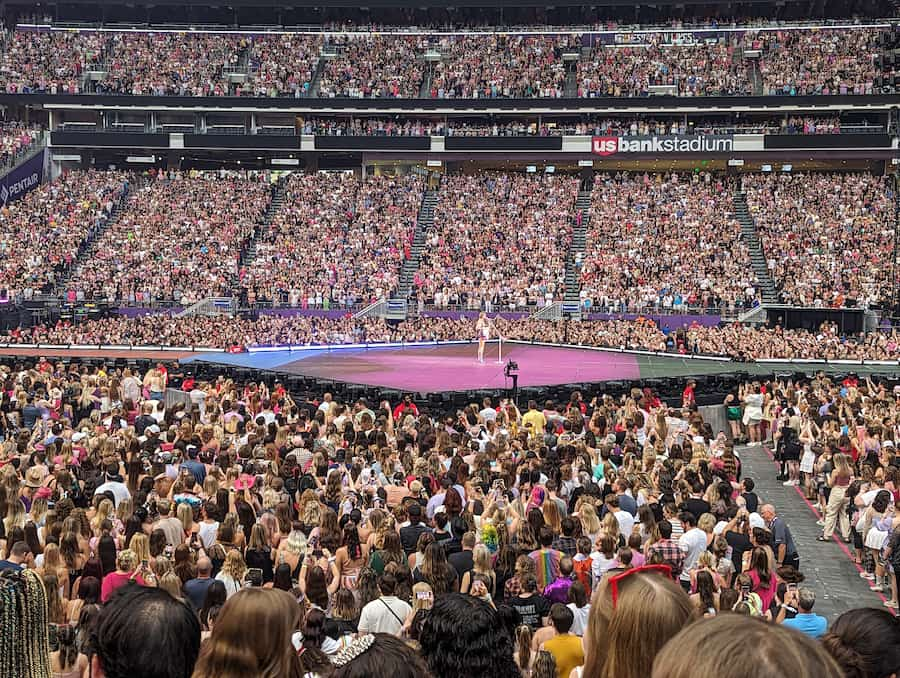 Taylor Swift surrounded by crowd at the Minneapolis Eras Tour. Photo credit: Michael Hicks