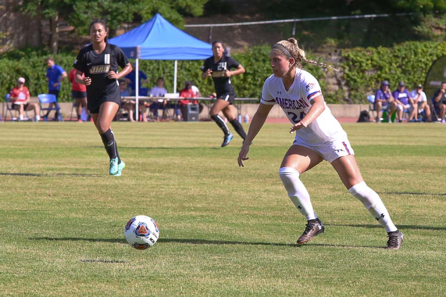 Jordan Mahony prepares to pass or shoot as opposing team runs towards her