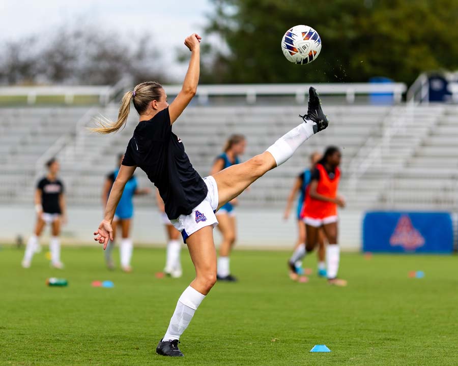 Brook Steel kicking soccer ball into the air