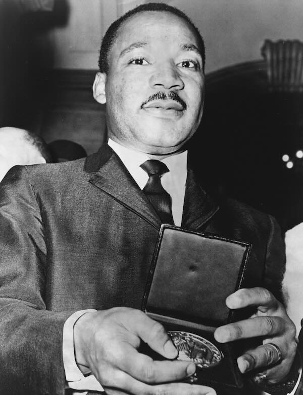 Dr Martin Luther King Jr receives a medal.