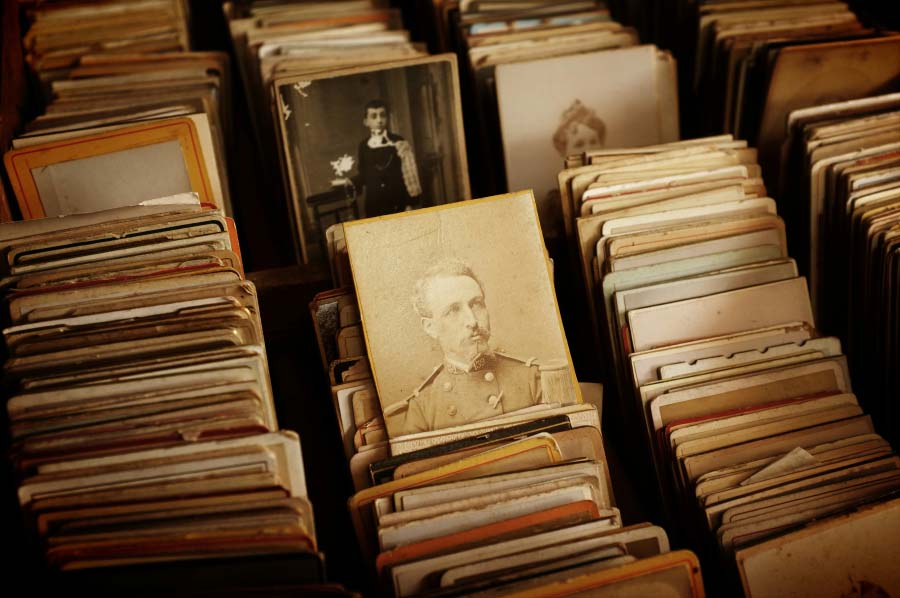 stack of antique photos and ephemera