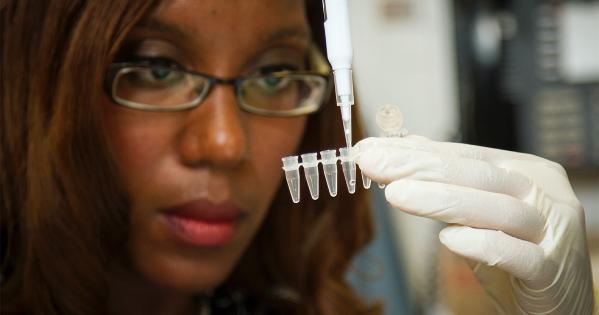 A person uses a pipette in a lab