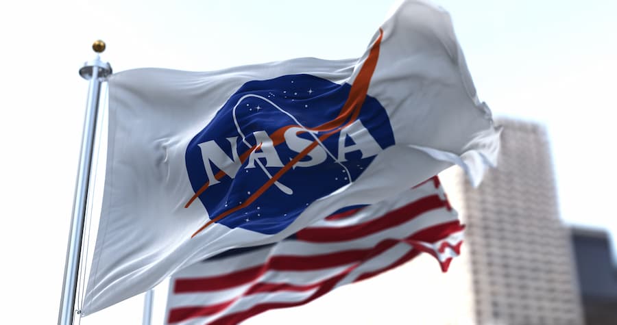 NASA flag waving in front of USA flag.