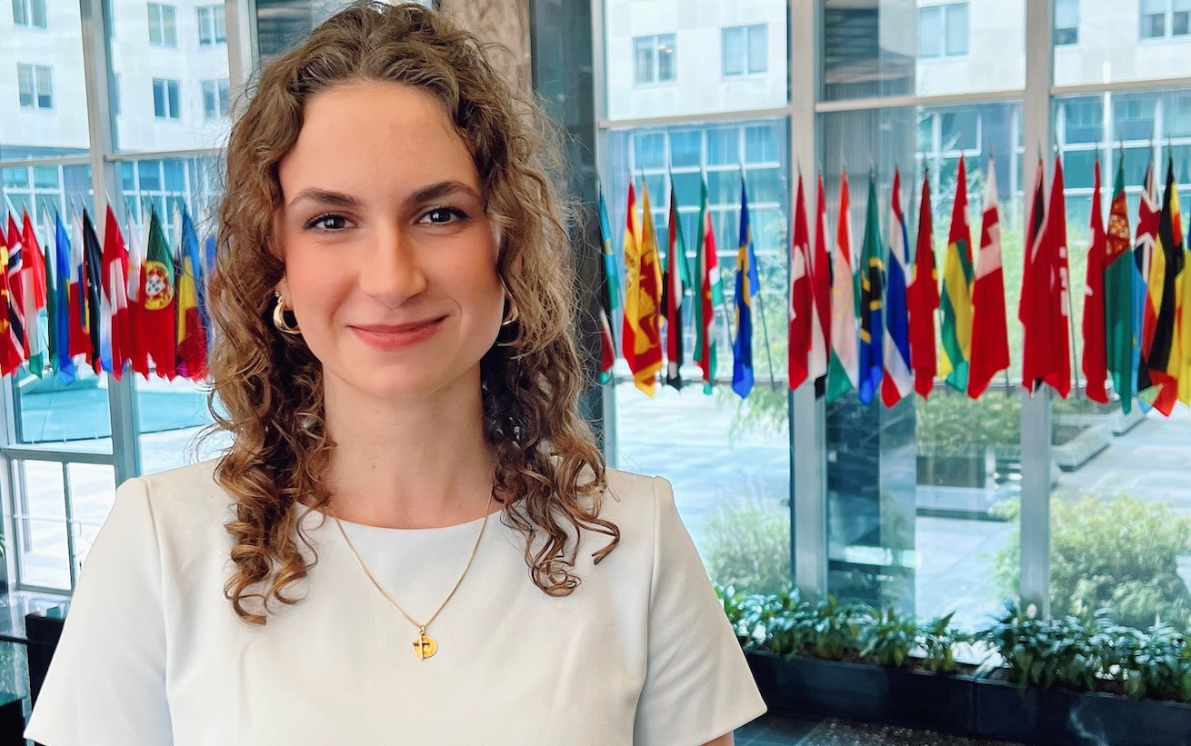 Francesca Gill in front of world flags.