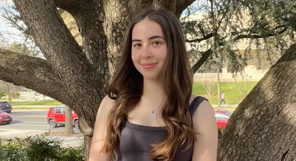 Chloe Leeds sitting outside on AU's campus