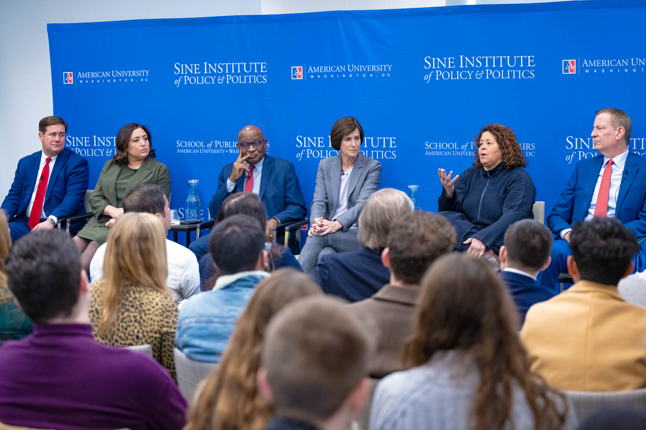 Speakers on a panel at a Sine event.