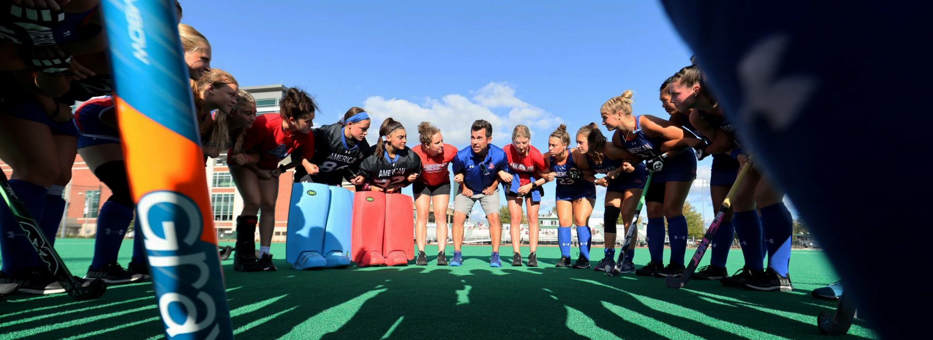 Hockey team gathered in a team huddle.