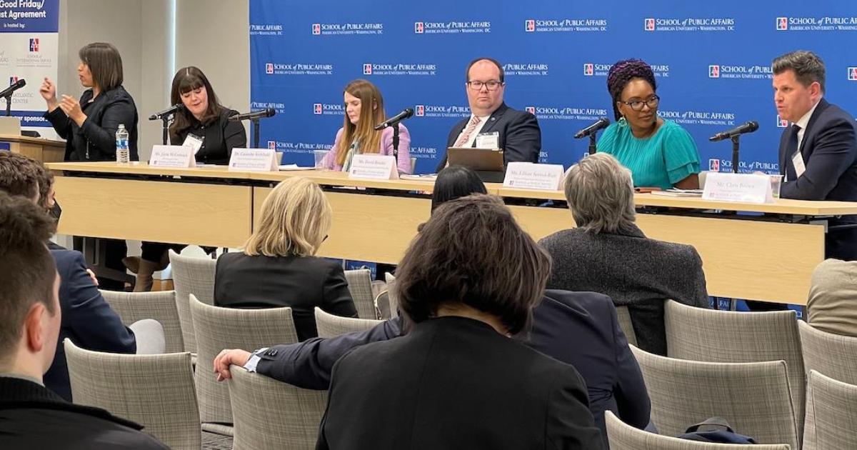 A panel discussion in front of an audience.