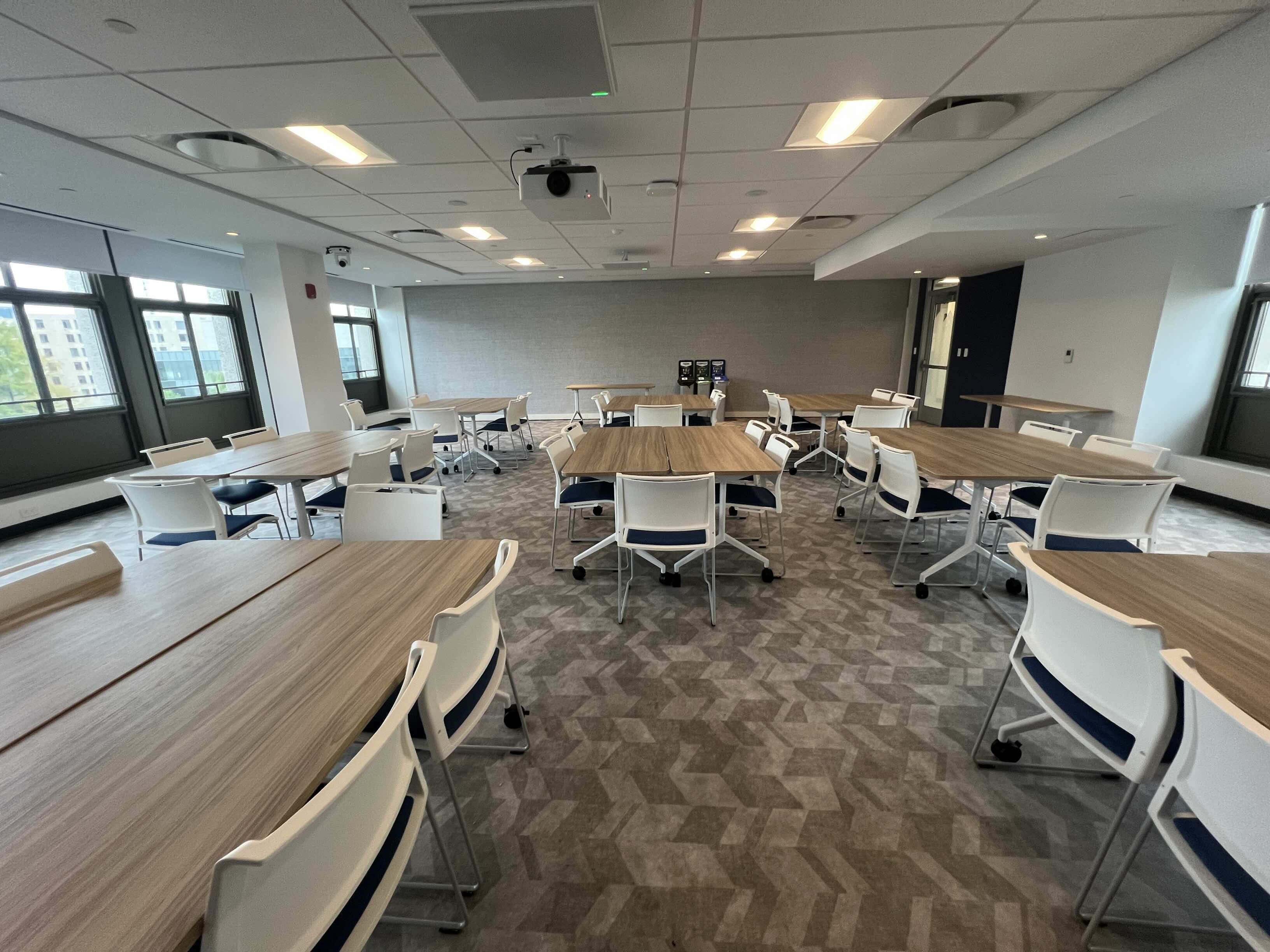 Tables arranged in a renovated gathering room in MGC.