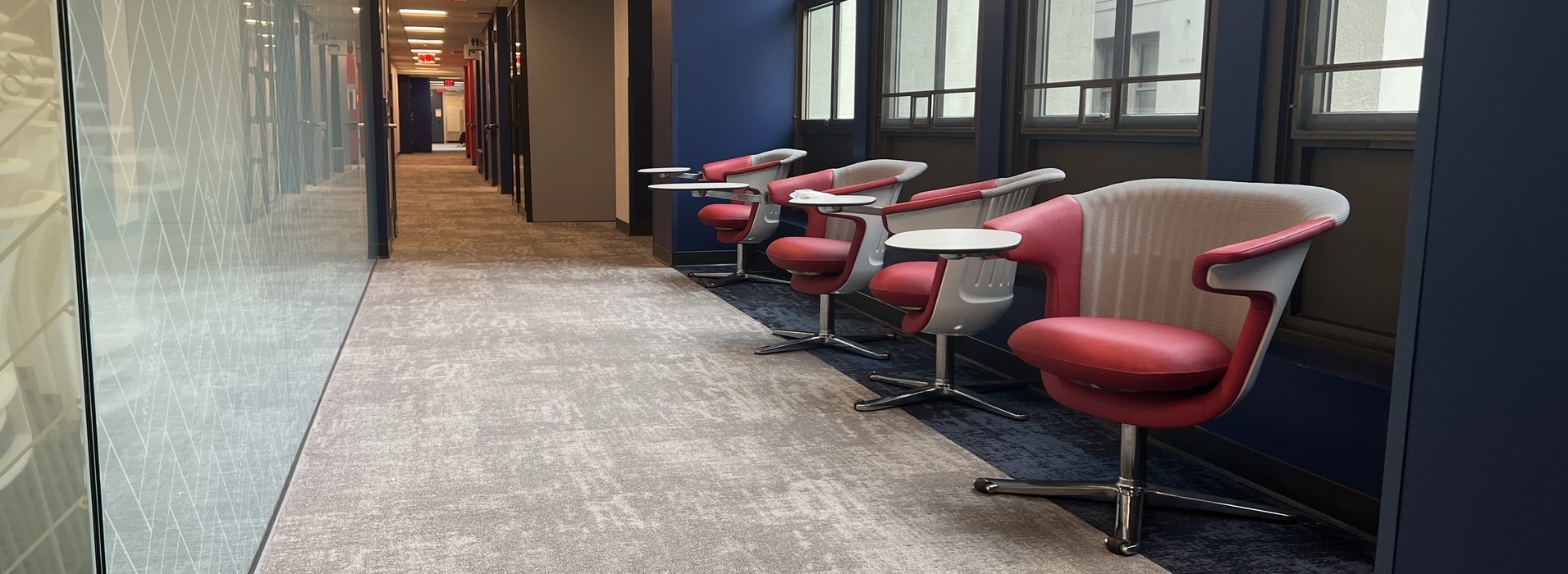 A row of red chairs in the renovated 3rd floor of MGC