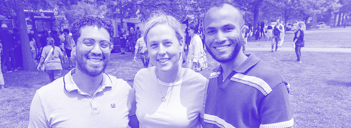 a smiling group of people outside on a sunny day