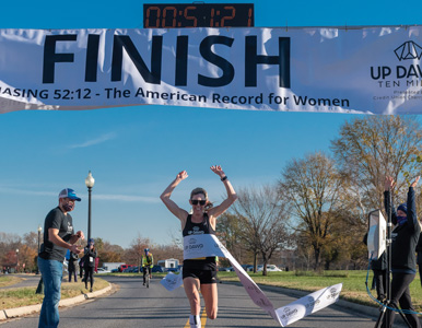 Keira D'Amato crosses the finish line of the Up Dawg Ten Miler in Anacostia Park