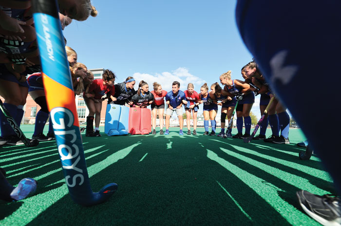 Steve Jennings surrounded by field hockey players