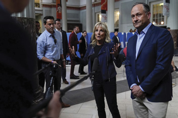 Michael LaRosa stands behind Jill Biden and Doug Emhoff  near press scrum