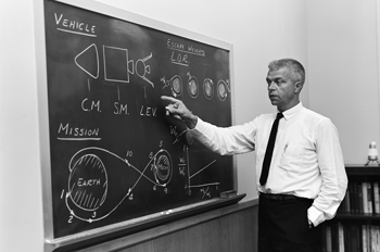 John Houbolt stands at a whiteboard to explain LOR