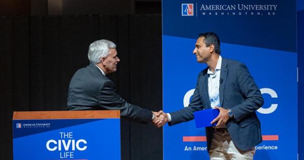 Patel and Alger shake hands. Photo by Jeff Watts.