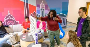 students play Connect Four in the residence hall