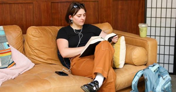 An AU student reads on a couch at the bridge. Photo by Ethan Kauffman.