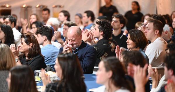 Unity Meal attendees clap during the event. Photo by Jeff Watts.