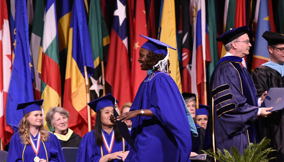 Grad student crossing the stage.