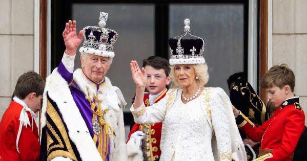 King Charles III and Queen Camilla waving during the coronation celebration.