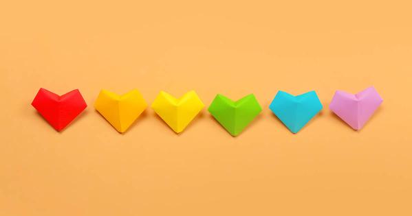 Six paper heart cut-outs in rainbow colors to represent a Pride flag