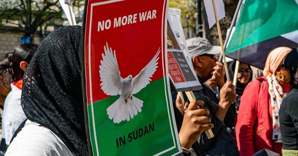 Protest sign that reads "No more war in Sudan" held by protester