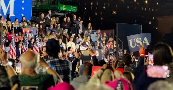 Kamala Harris speaks to thousands of people at a podium in downtown DC for her final rally