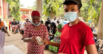 Ugoeze Achilike (right) on the ground in Nigeria