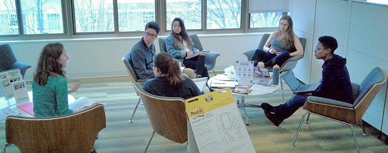 SOE students sitting the school lobby, learning