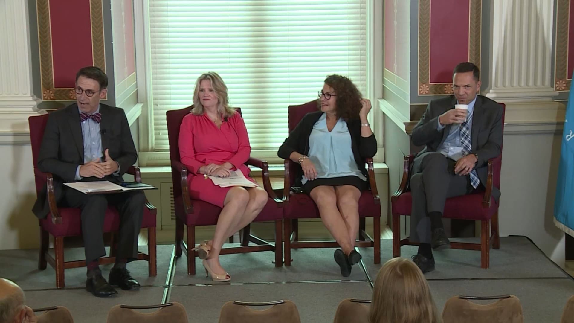 Four people sit for a panel.