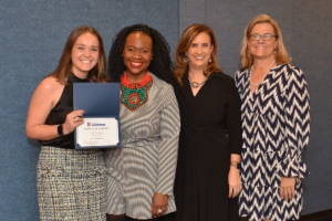 welead grad alyssa morrissey holding certificate wtih speaker and program leaders