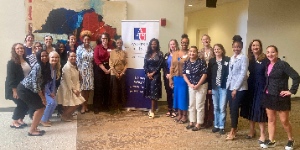 large group of women standing around professional banner