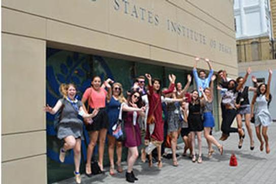 Students jump in the air.