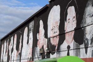 A mural of famous people of Black culture at the East River Park Shopping Center.