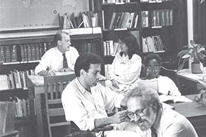 Davenport Memorial Lounge with several students and professors sitting at tables