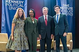 Two women and two men smiling on stage