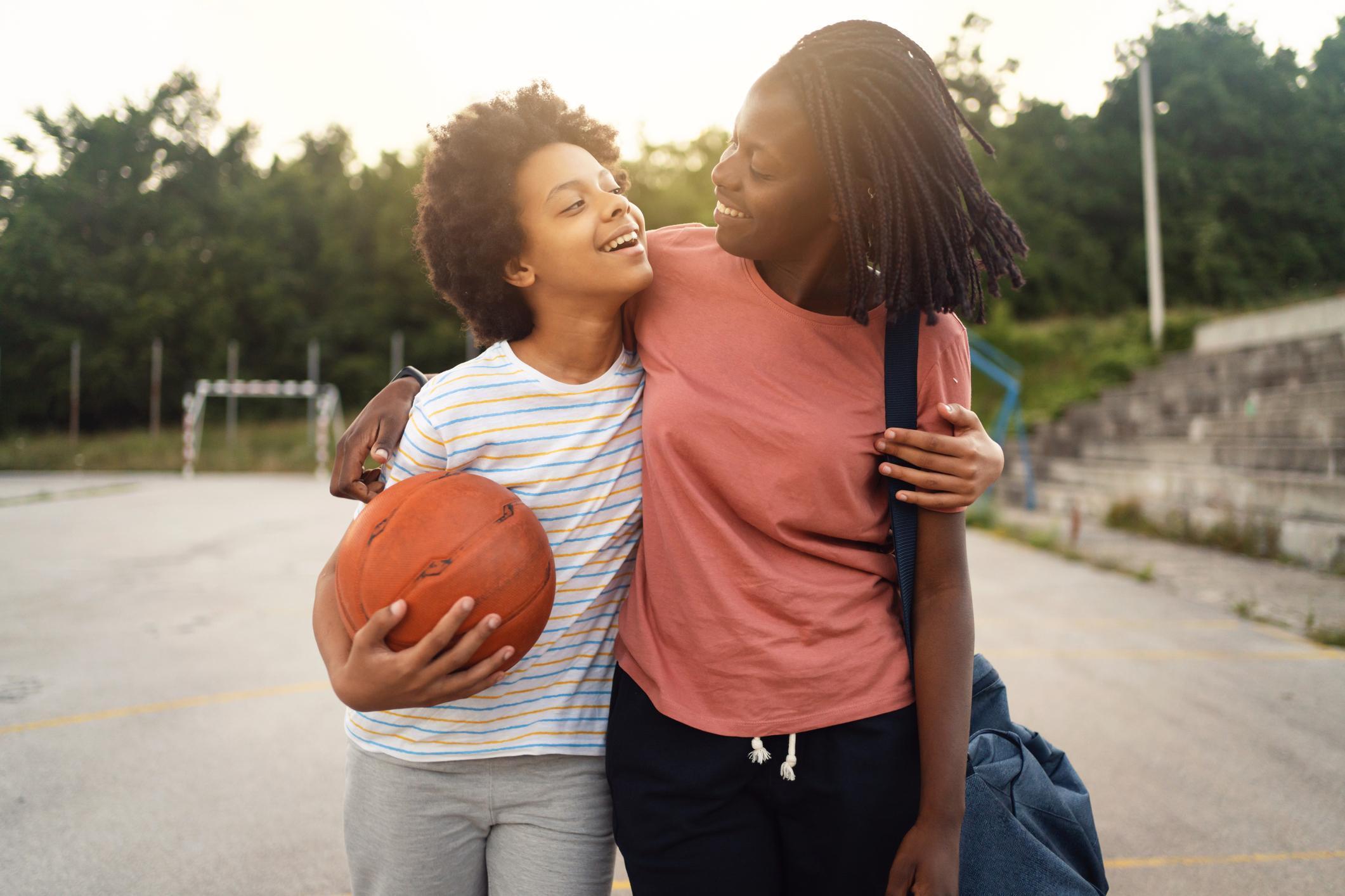 Photo of mom picking up teen daughter from sports practice